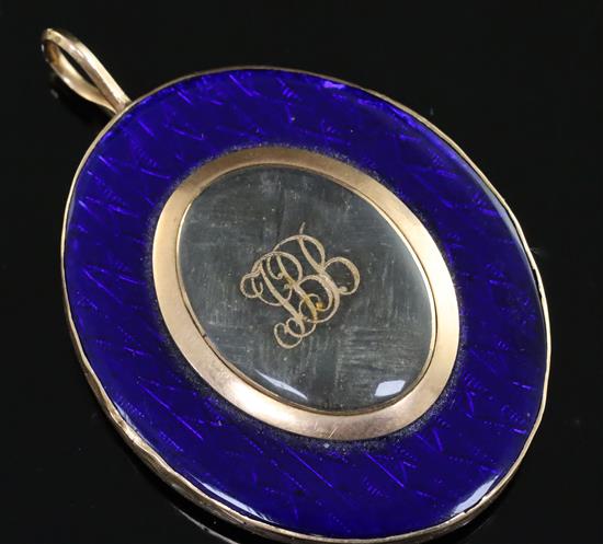 A 19th century gold and blue enamel set oval pendant, overall 56mm.